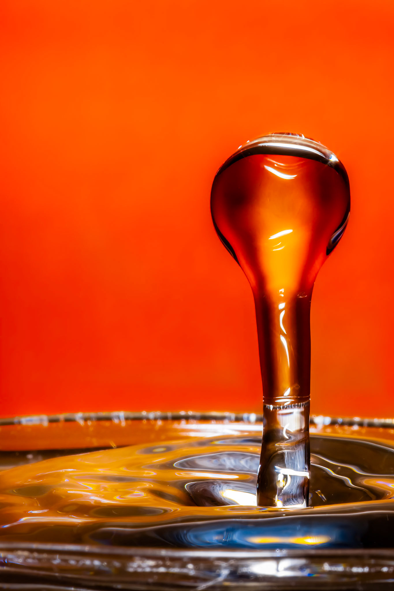 Water droplet against orange coloured card